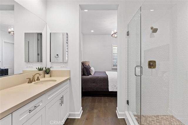 135 Via Artemesia, San Clemente, CA 92672 - full bathroom with vanity, a chandelier, a shower stall, wood-type flooring, and connected bathroom