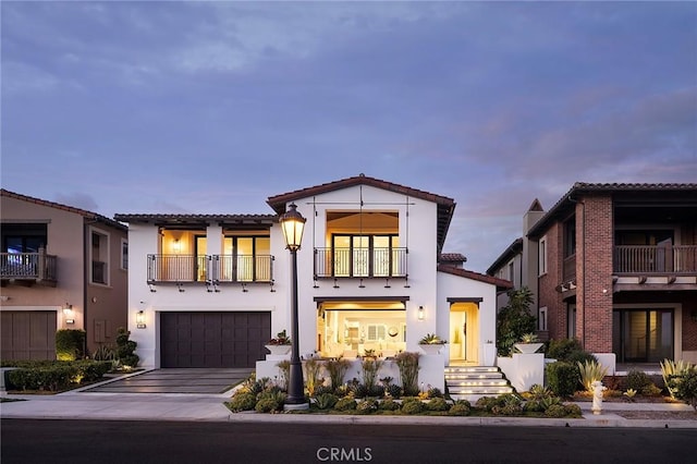 135 Via Artemesia, San Clemente, CA 92672 - mediterranean / spanish-style house with a balcony, a tiled roof, concrete driveway, an attached garage, and stucco siding