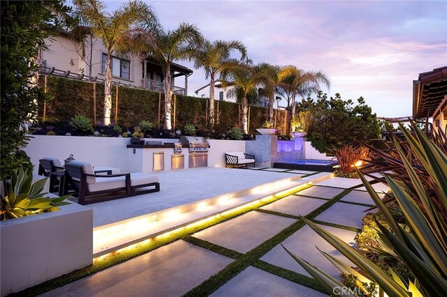 135 Via Artemesia, San Clemente, CA 92672 - patio terrace at dusk featuring exterior kitchen, a patio area, and a swimming pool