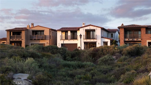 135 Via Artemesia, San Clemente, CA 92672 - view of front of home with a chimney, a balcony, stucco siding, and a tiled roof
