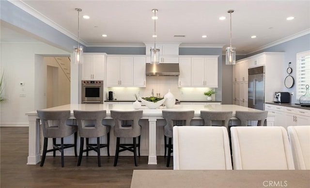 135 Via Artemesia, San Clemente, CA 92672 - kitchen with stainless steel appliances, extractor fan, decorative backsplash, white cabinetry, and a spacious island