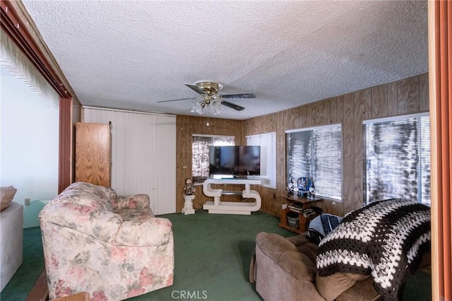 26218 Mccall Blvd, Menifee, CA 92586 - carpeted living area with a textured ceiling, wood walls, and ceiling fan