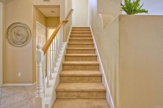 11590 Trailbrook Ln, San Diego, CA 92128 - staircase featuring tile patterned floors and baseboards