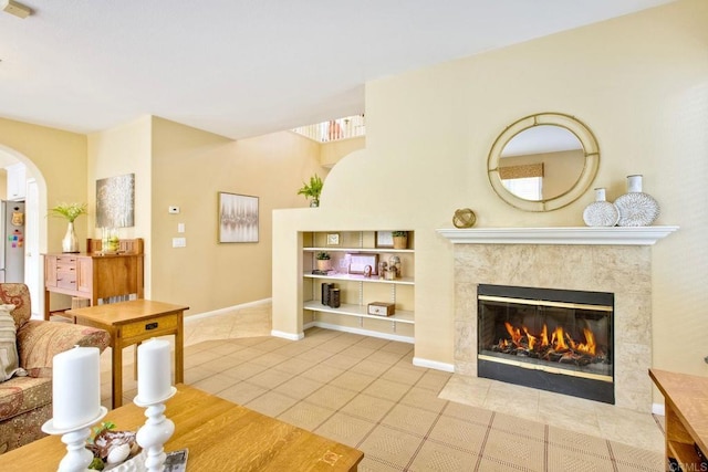11590 Trailbrook Ln, San Diego, CA 92128 - living room with a fireplace, tile patterned floors, arched walkways, baseboards, and built in features