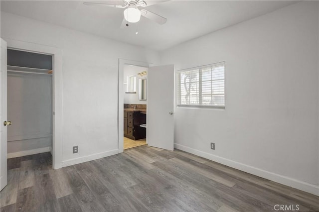 1550 E Sandison St, Wilmington, CA 90744 - unfurnished bedroom featuring baseboards, wood finished floors, a closet, ensuite bathroom, and a ceiling fan