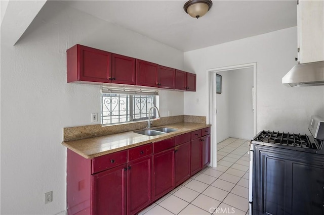1550 E Sandison St, Wilmington, CA 90744 - kitchen with a sink, gas range oven, red cabinets, under cabinet range hood, and light tile patterned flooring