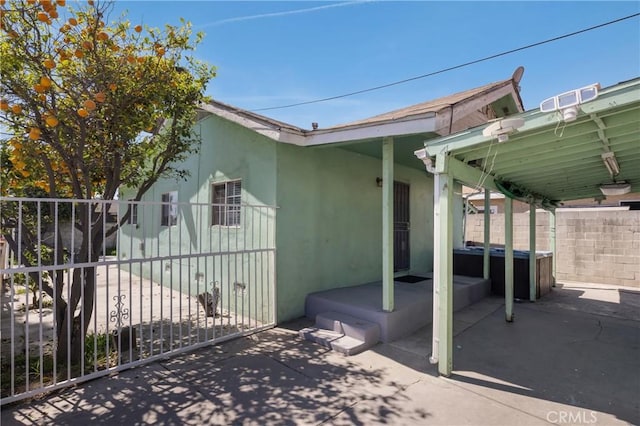 1550 E Sandison St, Wilmington, CA 90744 - view of side of home featuring stucco siding and a patio area