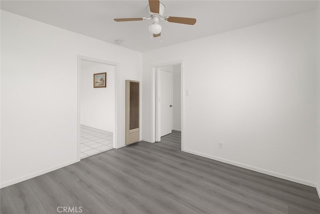 1550 E Sandison St, Wilmington, CA 90744 - unfurnished room featuring wood finished floors, a ceiling fan, baseboards, a smoke detector, and a heating unit