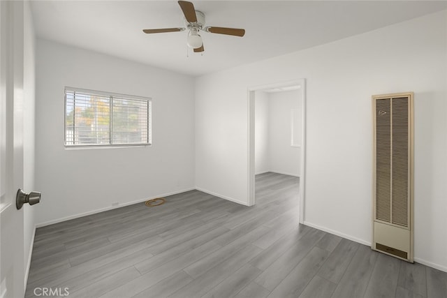 1550 E Sandison St, Wilmington, CA 90744 - spare room with a heating unit, ceiling fan, wood finished floors, and baseboards