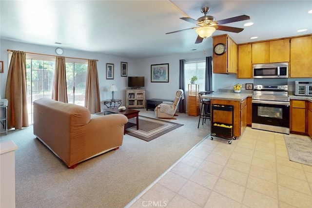 1401 Norton St, Oroville, CA 95966 - kitchen featuring appliances with stainless steel finishes, open floor plan, light countertops, brown cabinets, and a ceiling fan