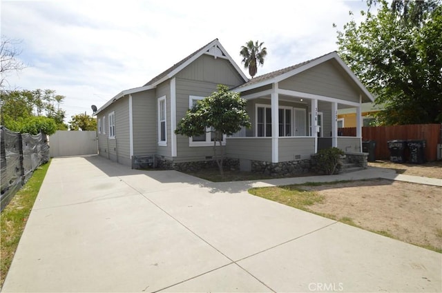 324 N Palomares St, Pomona, CA 91767 - view of front of house featuring fence, covered porch, and concrete driveway