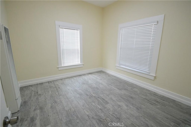 324 N Palomares St, Pomona, CA 91767 - unfurnished room featuring a heating unit, wood finished floors, and baseboards