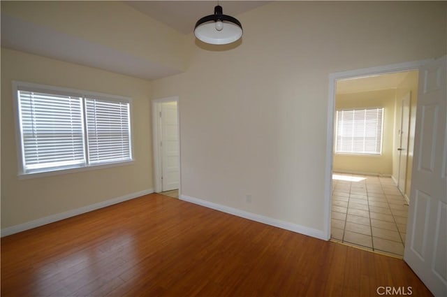 324 N Palomares St, Pomona, CA 91767 - spare room featuring baseboards, light wood-style flooring, and healthy amount of natural light