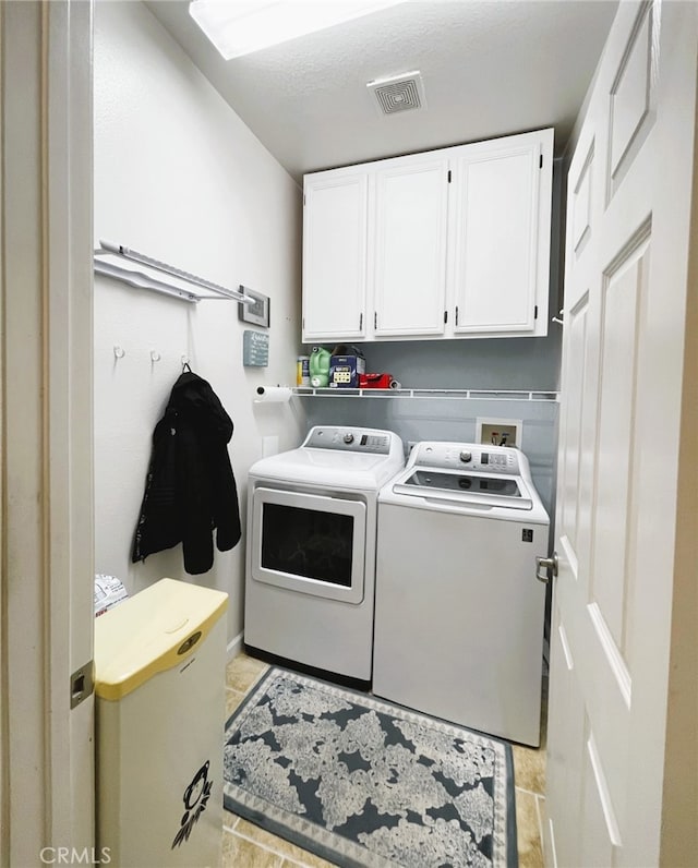 13217 Acacia Ave, Moreno Valley, CA 92553 - washroom with cabinet space, separate washer and dryer, and light tile patterned floors