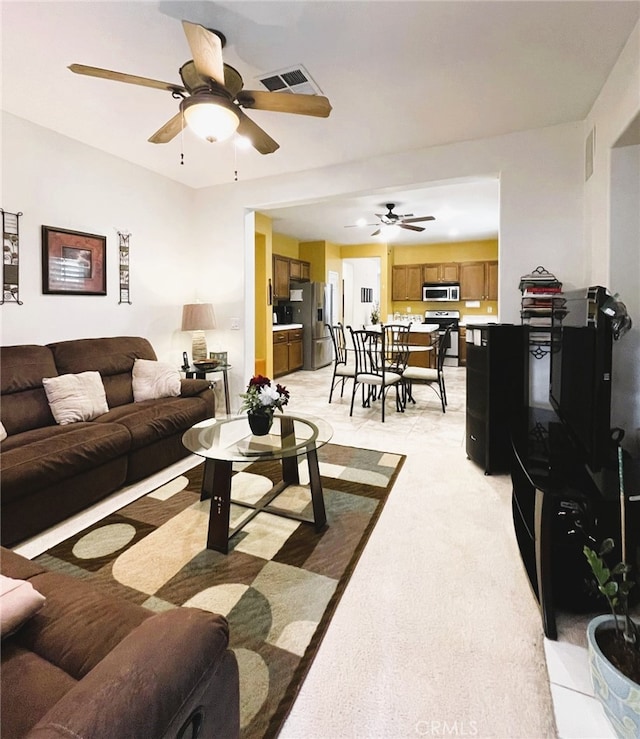 13217 Acacia Ave, Moreno Valley, CA 92553 - living room featuring a ceiling fan and light colored carpet