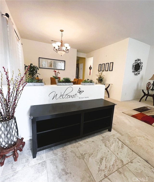 13217 Acacia Ave, Moreno Valley, CA 92553 - carpeted dining area with a chandelier
