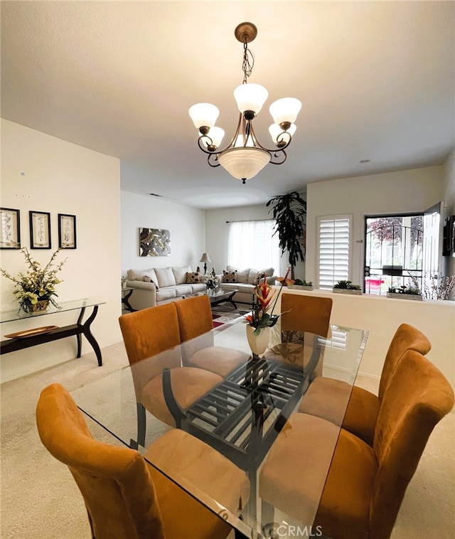13217 Acacia Ave, Moreno Valley, CA 92553 - dining room featuring carpet flooring and a chandelier