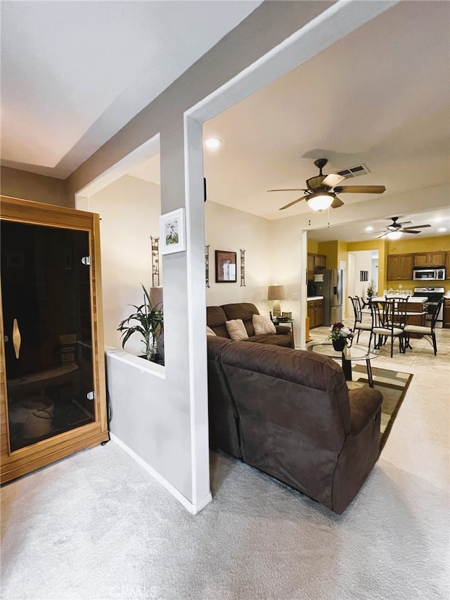 13217 Acacia Ave, Moreno Valley, CA 92553 - living area with a ceiling fan, light carpet, and baseboards