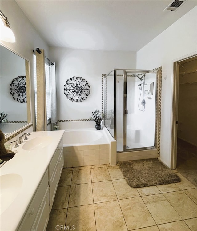 13217 Acacia Ave, Moreno Valley, CA 92553 - full bath with a stall shower, a garden tub, tile patterned flooring, double vanity, and a spacious closet