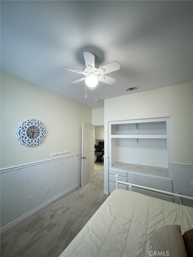 13217 Acacia Ave, Moreno Valley, CA 92553 - bedroom with a wainscoted wall, carpet, and ceiling fan