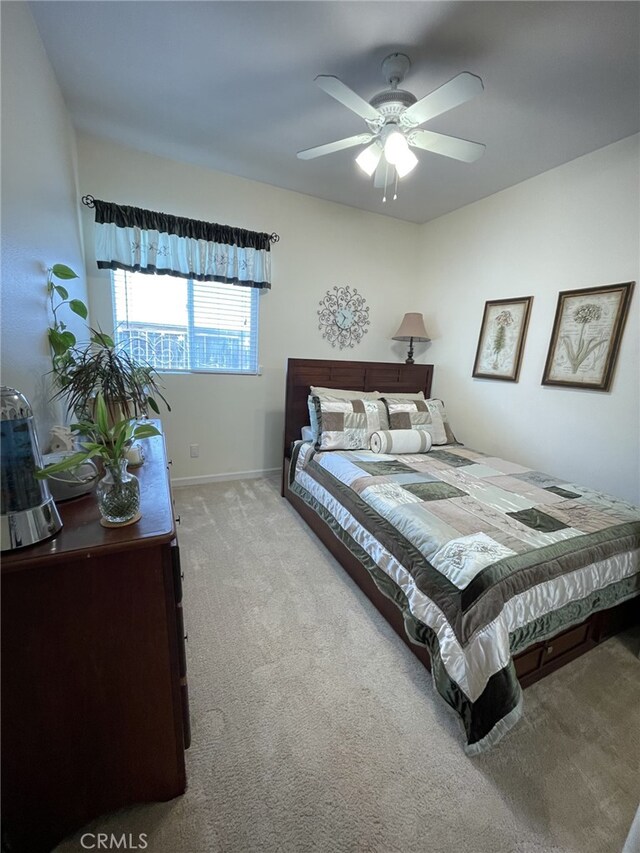 13217 Acacia Ave, Moreno Valley, CA 92553 - carpeted bedroom featuring baseboards and a ceiling fan