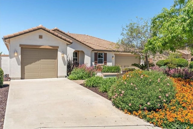 287 Tom Mcguinness Jr Cir, Fallbrook, CA 92028 - mediterranean / spanish-style house with a garage, stucco siding, driveway, and a tile roof