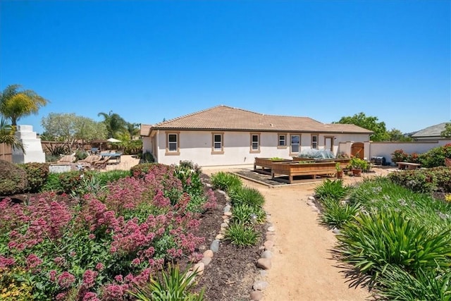 287 Tom Mcguinness Jr Cir, Fallbrook, CA 92028 - back of property with stucco siding and a garden