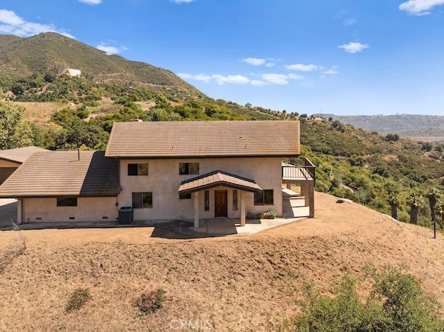 879 Stewart Canyon Rd, Fallbrook, CA 92028 - back of property featuring cooling unit, a mountain view, a patio area, and stucco siding