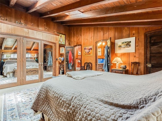 6570 Moonstone Beach Dr, Cambria, CA 93428 - bedroom featuring beamed ceiling, wood ceiling, wood walls, french doors, and carpet floors