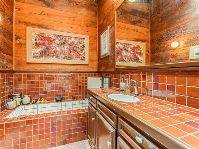 6570 Moonstone Beach Dr, Cambria, CA 93428 - bathroom with vanity, decorative backsplash, and wooden walls