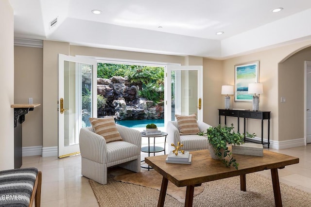 15450 Briarwood Dr, Sherman Oaks, CA 91403 - living room featuring light tile patterned flooring, arched walkways, baseboards, a raised ceiling, and recessed lighting