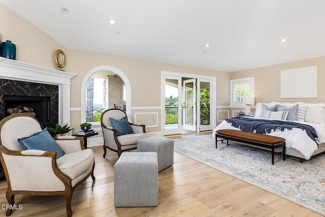 15450 Briarwood Dr, Sherman Oaks, CA 91403 - bedroom featuring access to outside, wainscoting, light wood-style floors, a premium fireplace, and a decorative wall