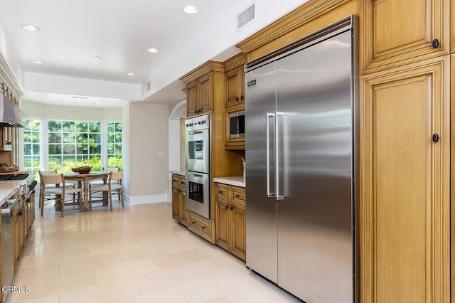 15450 Briarwood Dr, Sherman Oaks, CA 91403 - kitchen with appliances with stainless steel finishes, recessed lighting, brown cabinets, light countertops, and light tile patterned flooring