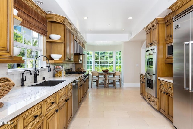 15450 Briarwood Dr, Sherman Oaks, CA 91403 - kitchen featuring a sink, appliances with stainless steel finishes, open shelves, tasteful backsplash, and brown cabinetry