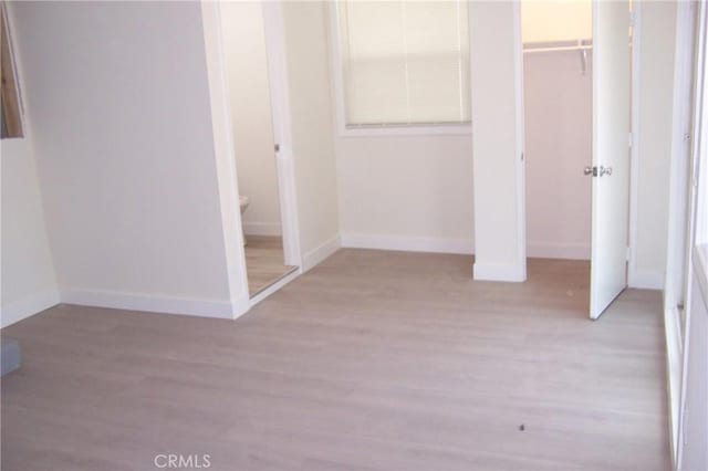 3069 N F St, San Bernardino, CA 92405 - unfurnished bedroom with a closet, baseboards, and wood finished floors