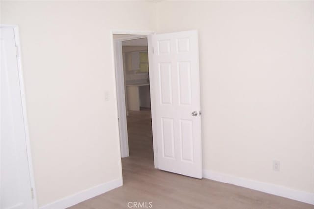3069 N F St, San Bernardino, CA 92405 - spare room with light wood-style flooring and baseboards