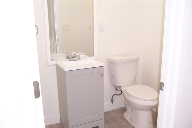 3069 N F St, San Bernardino, CA 92405 - bathroom featuring vanity, toilet, and wood finished floors