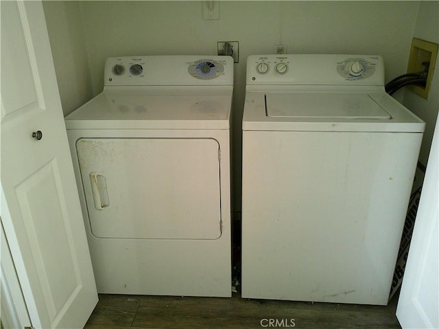 laundry room featuring separate washer and dryer and dark wood-style floors