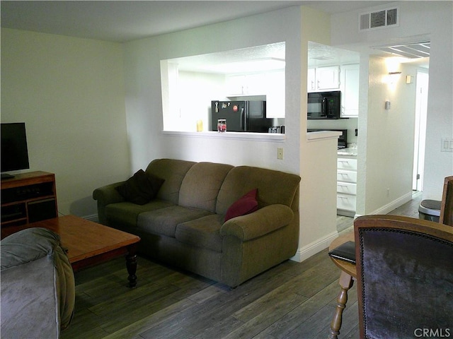 living room featuring wood finished floors and baseboards