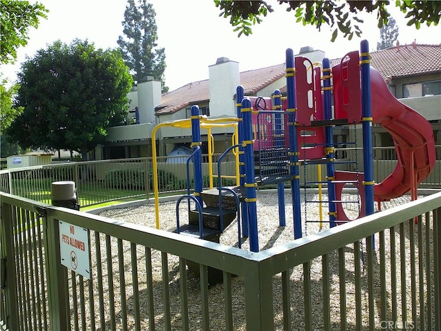 community jungle gym featuring fence