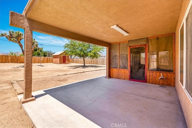 7566 Fox Trl, Yucca Valley, CA 92284 - view of patio featuring a storage shed, an outbuilding, and a fenced backyard