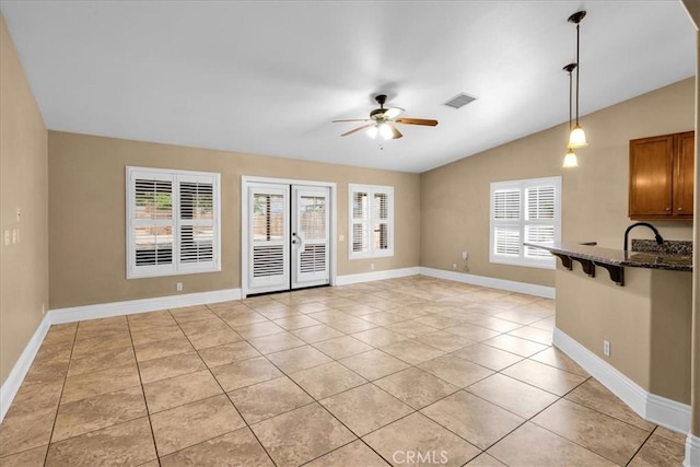 7566 Fox Trl, Yucca Valley, CA 92284 - unfurnished living room with ceiling fan, lofted ceiling, light tile patterned flooring, and baseboards