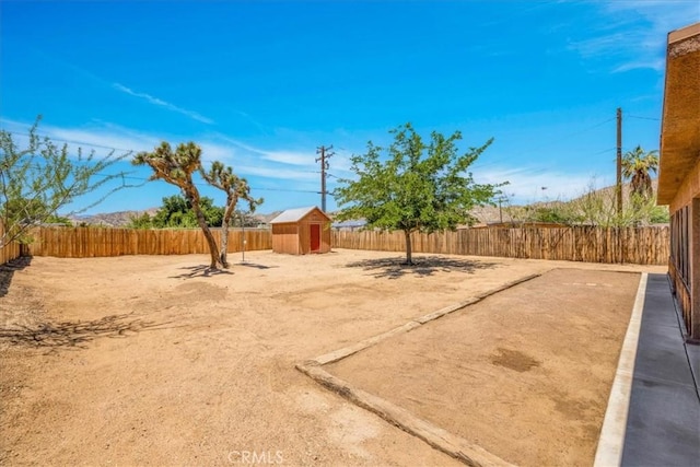 7566 Fox Trl, Yucca Valley, CA 92284 - fenced backyard featuring a storage shed and an outdoor structure