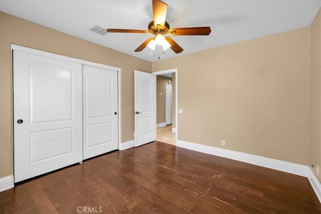 7566 Fox Trl, Yucca Valley, CA 92284 - unfurnished bedroom featuring baseboards, hardwood / wood-style floors, and a closet