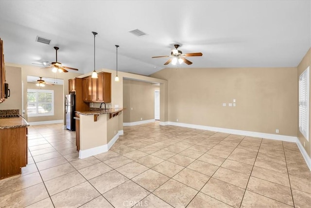7566 Fox Trl, Yucca Valley, CA 92284 - kitchen featuring freestanding refrigerator, ceiling fan, light tile patterned floors, and open floor plan