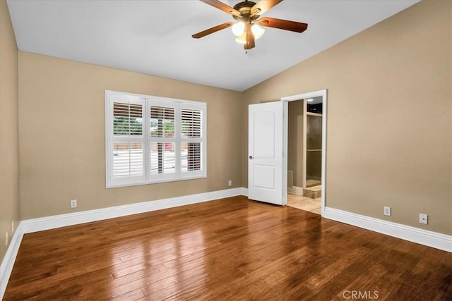7566 Fox Trl, Yucca Valley, CA 92284 - unfurnished bedroom with lofted ceiling, baseboards, wood-type flooring, ensuite bathroom, and a ceiling fan
