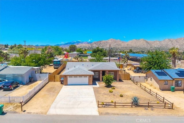 7566 Fox Trl, Yucca Valley, CA 92284 - ranch-style home featuring an attached garage, a mountain view, and driveway