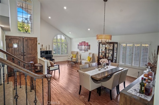 dining room featuring a chandelier, wood finished floors, high vaulted ceiling, recessed lighting, and baseboards