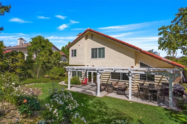 back of property featuring a pergola, stucco siding, a yard, and a patio area