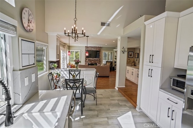 dining room with a towering ceiling, a chandelier, and recessed lighting